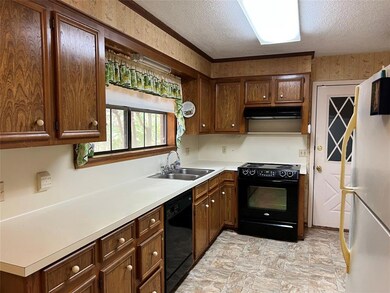 Double windows looking out into the back yard.  Door leads into garage for private entry from parking your vehicle.