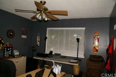 Bedroom has wood floor and custom paint. 