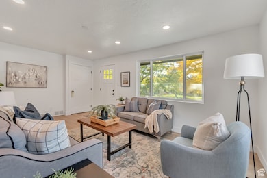 Living room featuring light wood-type flooring and recessed lighting