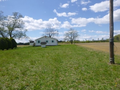 View of grassy yard with a rural view