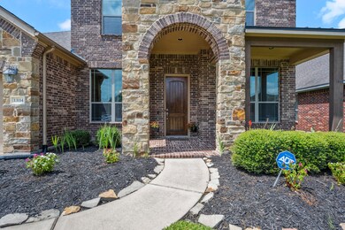 Inviting brick arch-way with a porch perfect for morning coffee.