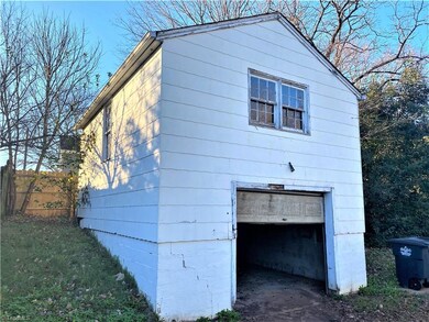Detached garage with a single car bay but a whole second floor for storage or man cave.
