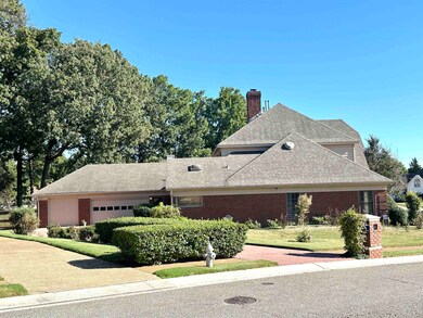 View of front of house with a front yard and a gar