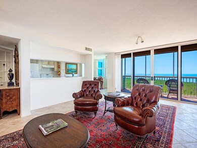Living area with a water view, light tile patterned floors, visible vents, and a wall of windows