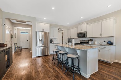 The beautiful white kitchen is accented with granite counter tops and stainless steel appliances.