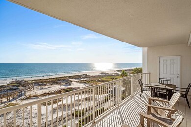 Balcony featuring view of water and beach