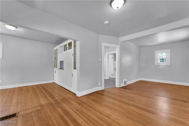 Spare room featuring hardwood / wood-style flooring and baseboards
