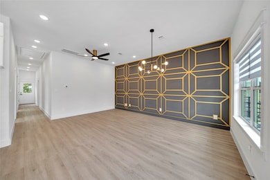 Living space features sleek wood flooring, a strik