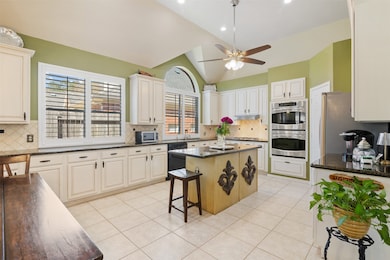 The kitchen is spacious and ready for the chef of the family. It has tile flooring, ceiling fan, canned lighting and large picture windows with shutters.