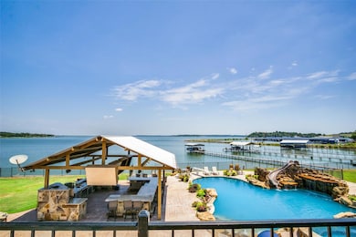 View of swimming pool with a boat dock, a water vi