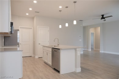 Kitchen with visible vents, an island with sink, w