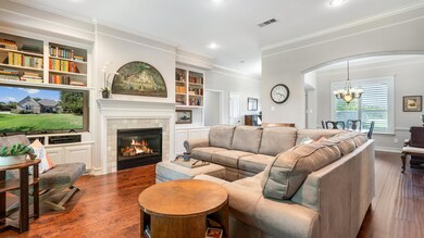 Living room with dark wood-type flooring, a firepl