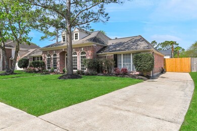This single story beauty offers a stately exterior with charming brick, well-kept landscaping, beautifully arched windows and lovely trees.