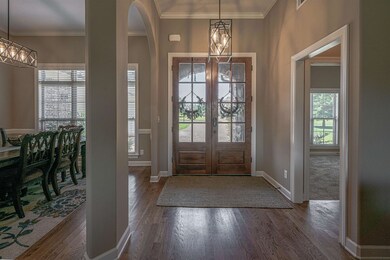 Foyer with a notable chandelier, ornamental moldin