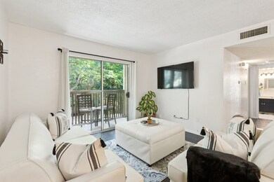 Spacious living room with natural light and a cozy layout—perfect for relaxing or entertaining.