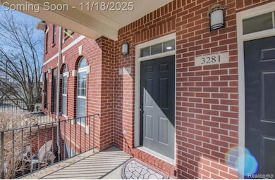 Entrance to property with brick siding and a porch