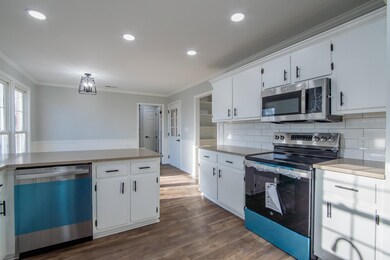Kitchen with white cabinets, stainless steel appli