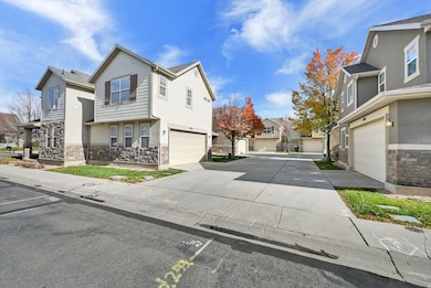 View of side of property with stone siding, a residential view, and driveway