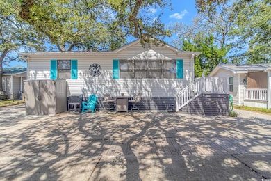 View of front of house featuring a wooden deck