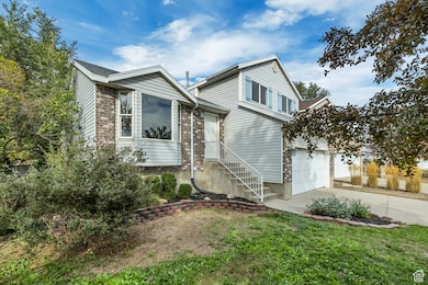 View of front of house featuring concrete driveway
