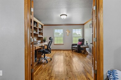 Office area featuring ornamental molding, wood finished floors, and baseboards