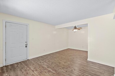 Unfurnished room featuring wood-type flooring, a t