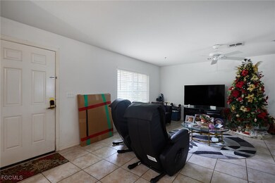 Living room with light tile patterned floors and a