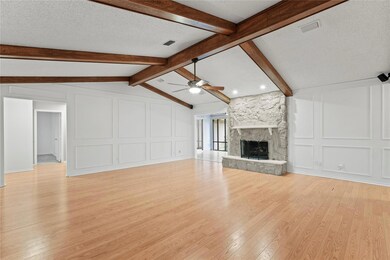 Unfurnished living room with ceiling fan, lofted c
