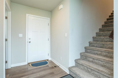 Entryway that leads to the 1/2 bathroom, living ro