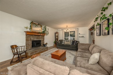 Living room featuring wood flooring and brick fireplace