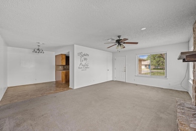 Unfurnished living room with carpet, visible vent