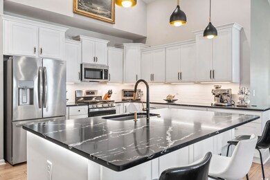 Kitchen with stainless steel appliances, a sink, a