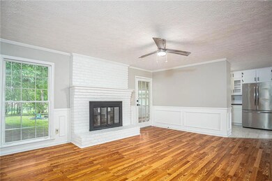 Unfurnished living room featuring light wood-style