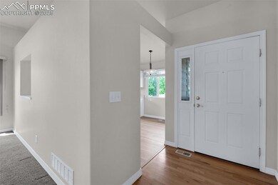 Entrance foyer featuring baseboards and wood finished floors