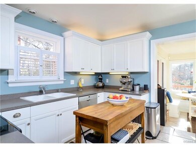 The kitchen has been renovated and has white cabin