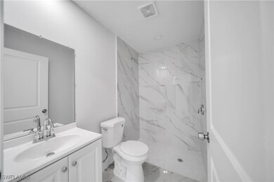 Full bath with visible vents, marble finish floor,