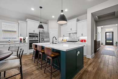 Kitchen with dark wood-type flooring, decorative 