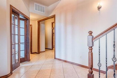Foyer featuring french doors and light tile floori