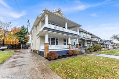 View of front facade featuring a front yard, a porch, and a balcony