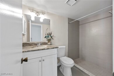 Primary Bathroom featuring tiled shower, toilet, a