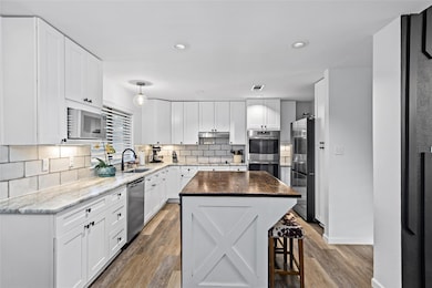 Kitchen with stainless steel appliances, a sink, 