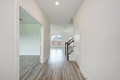 Hall with wood finished floors, stairs, and reces