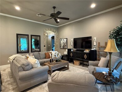 Living room featuring arched walkways, a ceiling f