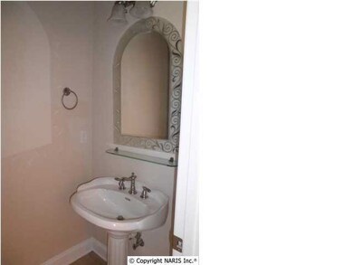 The half bath with tile floor sits just off the foyer.