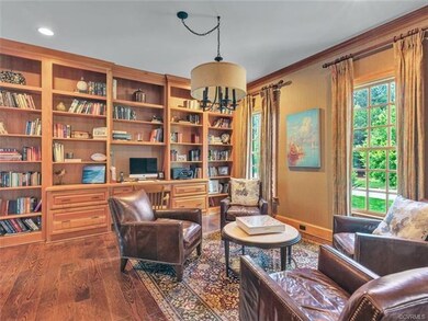 Office/Library with built in bookcases on two walls. Pocket doors, crown moulding, windows facing the front yard