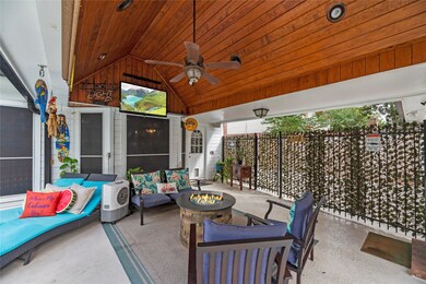 Private outdoor entertainment area with beautiful woodwork on ceiling.