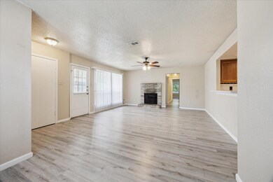 Unfurnished living room with ceiling fan, a stone