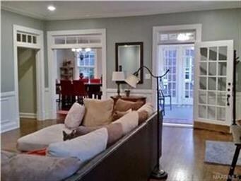 Living room opens up to sunroom and dining room