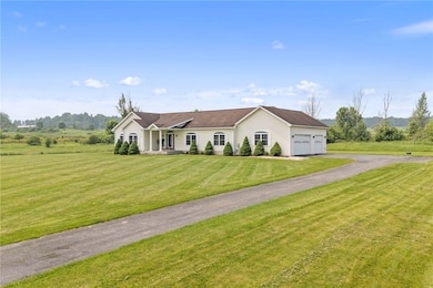 Paved driveway & thee car oversized garage