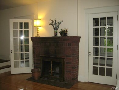 Fireplace in LR with double French doors to heated